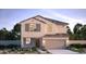 Charming two-story home boasting a stucco facade, two-car garage, and tidy front yard with desert landscaping at 17074 W Seldon Ln, Waddell, AZ 85355