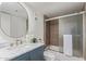 Bathroom with marble countertop, modern sink, and shower with a glass door at 1730 W Emelita Ave # 2033, Mesa, AZ 85202