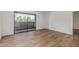 Bright bedroom with sliding glass door and wood-look flooring at 1730 W Emelita Ave # 2033, Mesa, AZ 85202