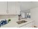 Close-up of a kitchen sink, marble countertop and cabinets leading to open layout at 1730 W Emelita Ave # 2033, Mesa, AZ 85202