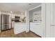 Charming kitchen with stainless appliances, white cabinetry, and a convenient laundry area at 1730 W Emelita Ave # 2033, Mesa, AZ 85202