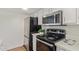 Efficient kitchen layout with stainless steel appliances and sleek countertops at 1730 W Emelita Ave # 2033, Mesa, AZ 85202