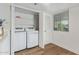 Convenient laundry area featuring modern washer and dryer, alongside ample shelving at 1730 W Emelita Ave # 2033, Mesa, AZ 85202