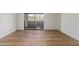 Open living room showcasing wood-look flooring and sliding glass doors at 1730 W Emelita Ave # 2033, Mesa, AZ 85202