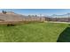 Backyard featuring artificial grass, a hammock, cornhole and a batting cage for outdoor relaxation and activities at 17980 W Meadowbrook Ave, Goodyear, AZ 85395