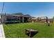 Large backyard featuring lush turf, playground, and relaxing patio area at 17980 W Meadowbrook Ave, Goodyear, AZ 85395