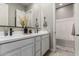 Bright bathroom with double vanity, stylish mirror, and an adjacent shower/tub combo at 17980 W Meadowbrook Ave, Goodyear, AZ 85395