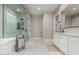 Bathroom featuring a walk-in shower, soaking tub, and double sink vanity with marble flooring at 17980 W Meadowbrook Ave, Goodyear, AZ 85395