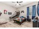Bright bedroom with a ceiling fan and a basketball game attached to the wall at 17980 W Meadowbrook Ave, Goodyear, AZ 85395