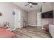 Spacious bedroom with wood-look flooring and a playhouse; light, neutral walls at 17980 W Meadowbrook Ave, Goodyear, AZ 85395