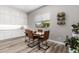 Cozy dining area with wood floors, natural light, and a modern table with leather chairs at 17980 W Meadowbrook Ave, Goodyear, AZ 85395