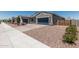 Beautiful stucco home with desert landscaping, two-car garage, and side yard access at 17980 W Meadowbrook Ave, Goodyear, AZ 85395