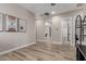 Bright hallway features wood-look flooring, white trim, and neutral paint at 17980 W Meadowbrook Ave, Goodyear, AZ 85395