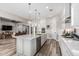Open kitchen boasts a spacious island, stainless appliances, and seamless flow into the living area at 17980 W Meadowbrook Ave, Goodyear, AZ 85395