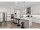 Well-lit kitchen features a spacious island with barstool seating and stainless steel appliances at 17980 W Meadowbrook Ave, Goodyear, AZ 85395