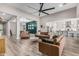 Spacious living room with wood floors, neutral walls, and modern seating arrangements at 17980 W Meadowbrook Ave, Goodyear, AZ 85395