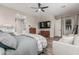 Primary bedroom featuring an ensuite bathroom, seating area, and ample natural light at 17980 W Meadowbrook Ave, Goodyear, AZ 85395