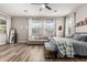 Bright main bedroom featuring a cozy sitting area and large windows at 17980 W Meadowbrook Ave, Goodyear, AZ 85395
