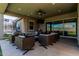 Spacious outdoor patio with comfortable seating and TV, ideal for entertaining at 17980 W Meadowbrook Ave, Goodyear, AZ 85395