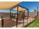 Backyard playground featuring a climbing wall, swings, a playhouse and artificial grass at 17980 W Meadowbrook Ave, Goodyear, AZ 85395