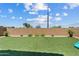 Well-maintained backyard with artificial turf, desert landscaping, a block wall, and a slide at 1800 S Jesse Pl, Chandler, AZ 85286