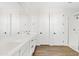 Bathroom with double sinks, modern vanity, a large mirror, white cabinets, and a frameless glass shower at 1800 S Jesse Pl, Chandler, AZ 85286