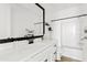 Modern bathroom featuring a white vanity, black accents, and a shower-tub combo for a sleek look at 1800 S Jesse Pl, Chandler, AZ 85286