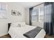 A cozy bedroom featuring neutral tones, soft bedding, and natural light from the window at 1800 S Jesse Pl, Chandler, AZ 85286