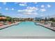 The community pool offers ample space for swimming and relaxation with various seating options and shade at 1800 S Jesse Pl, Chandler, AZ 85286
