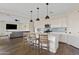 The open-concept kitchen features a large island, white cabinets, and stainless steel appliances at 1800 S Jesse Pl, Chandler, AZ 85286