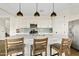 A modern kitchen with a large island, pendant lighting, stainless steel appliances, and white cabinets at 1800 S Jesse Pl, Chandler, AZ 85286