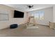 Spacious playroom with wood paneled accent wall, climbing gym, and ample natural light from the large windows at 1800 S Jesse Pl, Chandler, AZ 85286