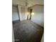 Carpeted bedroom features a ceiling fan, closet, and natural light at 201 S Greenfield Rd # 118, Mesa, AZ 85206