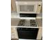 Close up of a black and white oven and microwave in the kitchen area at 201 S Greenfield Rd # 118, Mesa, AZ 85206
