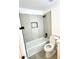Bathroom featuring white bathtub, tiled shower, and a modern black shower head at 20917 N 37Th Pl, Phoenix, AZ 85050