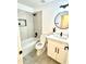 Bright bathroom with modern vanity, round mirror, and tiled shower-bath combination at 20917 N 37Th Pl, Phoenix, AZ 85050