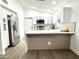 Lovely kitchen with a breakfast bar, white cabinets, and stainless steel refrigerator at 20917 N 37Th Pl, Phoenix, AZ 85050