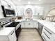 A view of the remodeled kitchen featuring sleek appliances, white cabinetry and tile backsplash at 20917 N 37Th Pl, Phoenix, AZ 85050