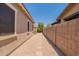 Side yard featuring rock landscaping, a small strip of grass, and a stone path at 22851 S 229Th Pl, Queen Creek, AZ 85142