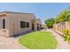 Beautiful backyard featuring a cozy lounge area, well maintained lawn and private fence at 22851 S 229Th Pl, Queen Creek, AZ 85142