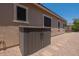Backyard featuring gravel, a storage bin, and concrete pavers leading to a landscaped area at 22851 S 229Th Pl, Queen Creek, AZ 85142