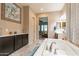Primary bath featuring a soaking tub, separate vanities, and views into the bedroom at 22851 S 229Th Pl, Queen Creek, AZ 85142