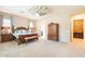 A spacious bedroom with a windmill ceiling fan and a large wardrobe at 22851 S 229Th Pl, Queen Creek, AZ 85142