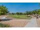 Inviting community park featuring a grassy area with walking paths and mature trees, perfect for outdoor recreation at 22851 S 229Th Pl, Queen Creek, AZ 85142