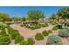 Beautiful community park with walking paths, lush landscaping, and mature trees creates a serene outdoor space at 22851 S 229Th Pl, Queen Creek, AZ 85142