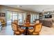 This dining room features a round table with seating for six and sliding glass doors to the outdoor patio at 22851 S 229Th Pl, Queen Creek, AZ 85142