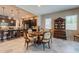 Stylish dining area with a round table adjacent to an open kitchen, ideal for Gathering gatherings at 22851 S 229Th Pl, Queen Creek, AZ 85142