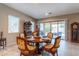 Elegant dining room with a round table, decorative chairs, and access to the outdoor patio at 22851 S 229Th Pl, Queen Creek, AZ 85142