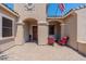 Inviting front porch with covered seating area, stone flooring, and an American flag waving at 22851 S 229Th Pl, Queen Creek, AZ 85142
