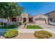Charming single-story home with manicured landscaping, covered porch, and a two-car garage at 22851 S 229Th Pl, Queen Creek, AZ 85142